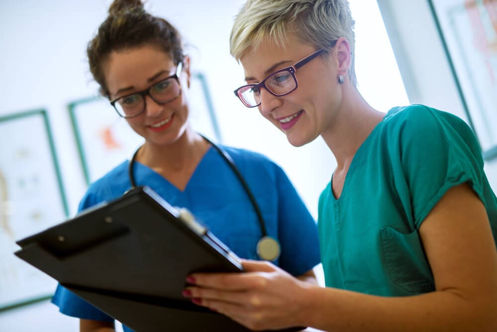 Nurses reviewing patients medical records