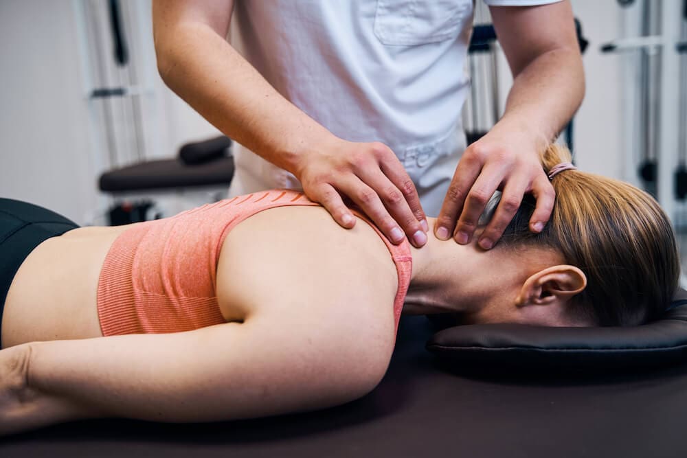 chiropractor helping a patient with neck pain