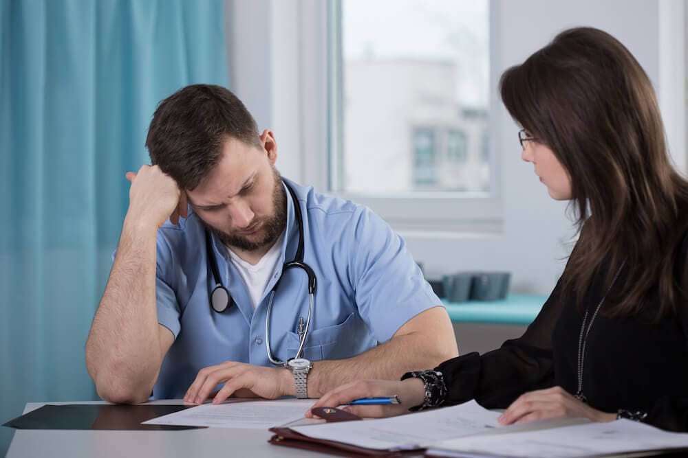 nurse talking to a lawyer about a disciplinary case against his license